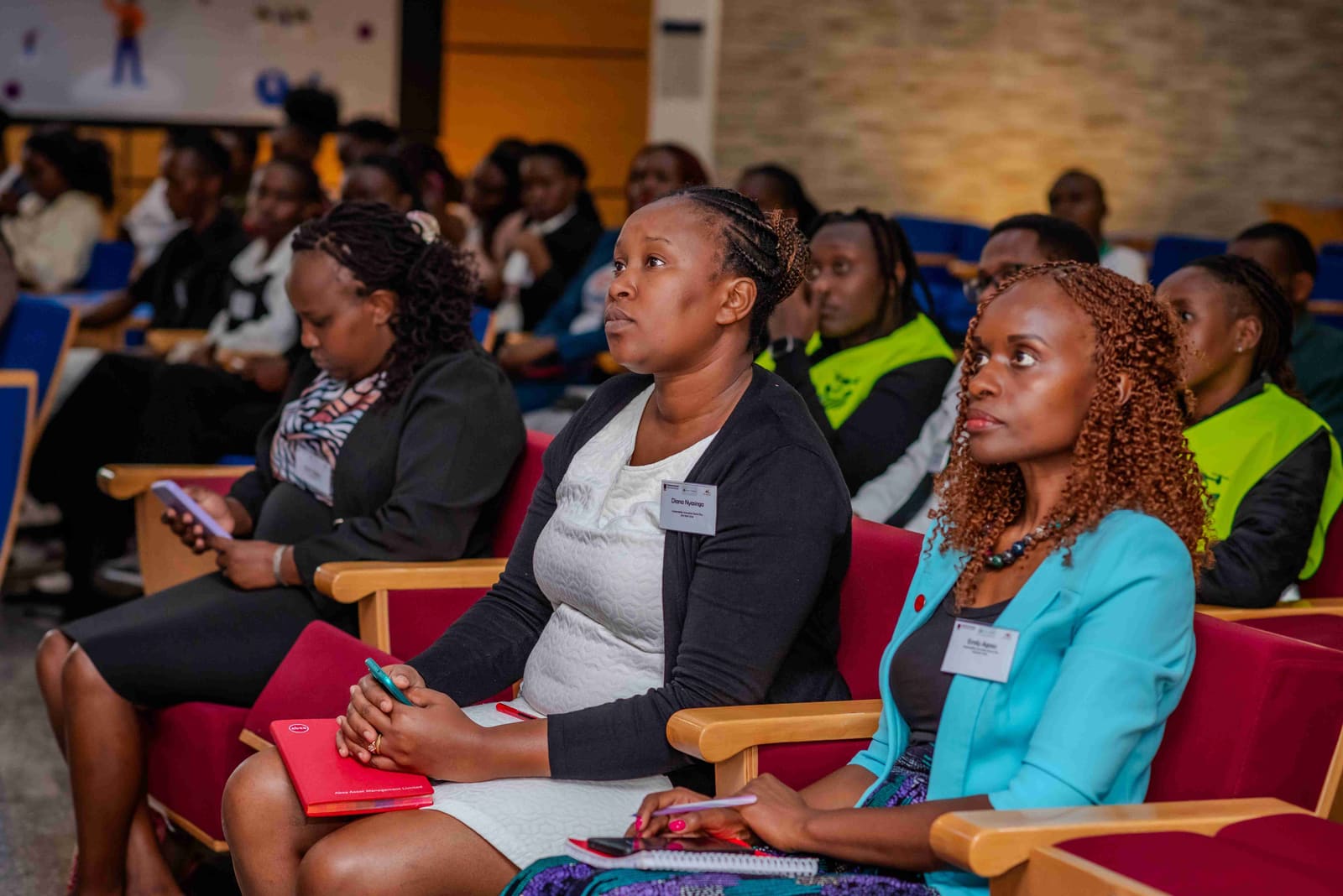 Faces in the room — the next cohort listens.